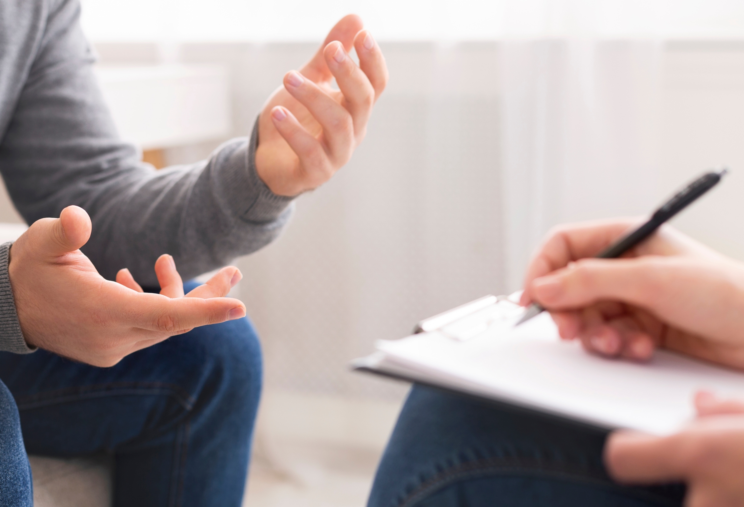 Psychologist taking notes during a custody evaluation interview