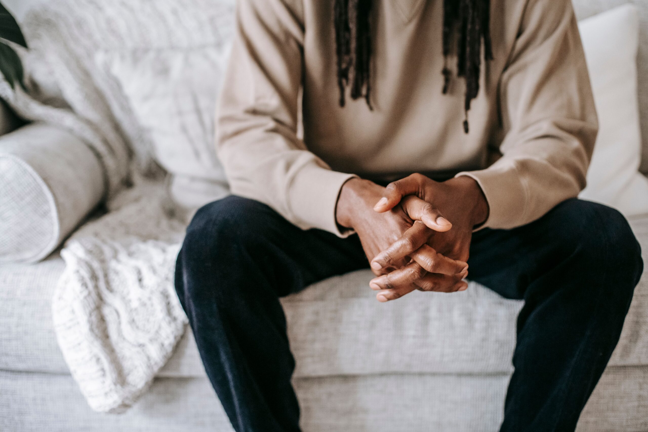 Client seated on a couch at the start of a therapy session