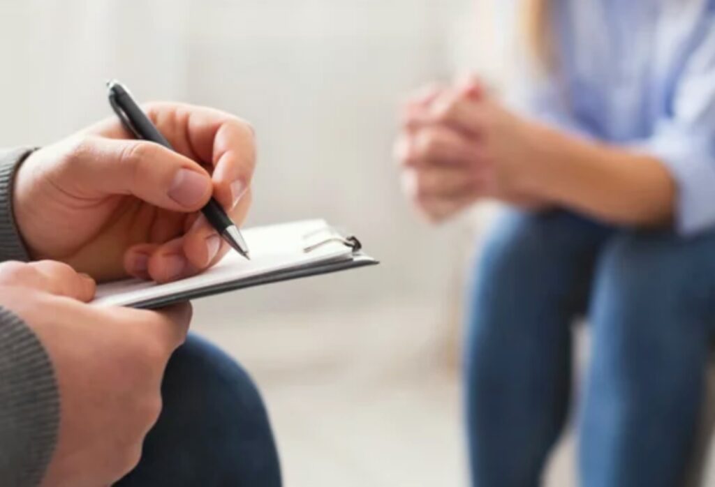 Psychologist taking notes during a psychological assessment