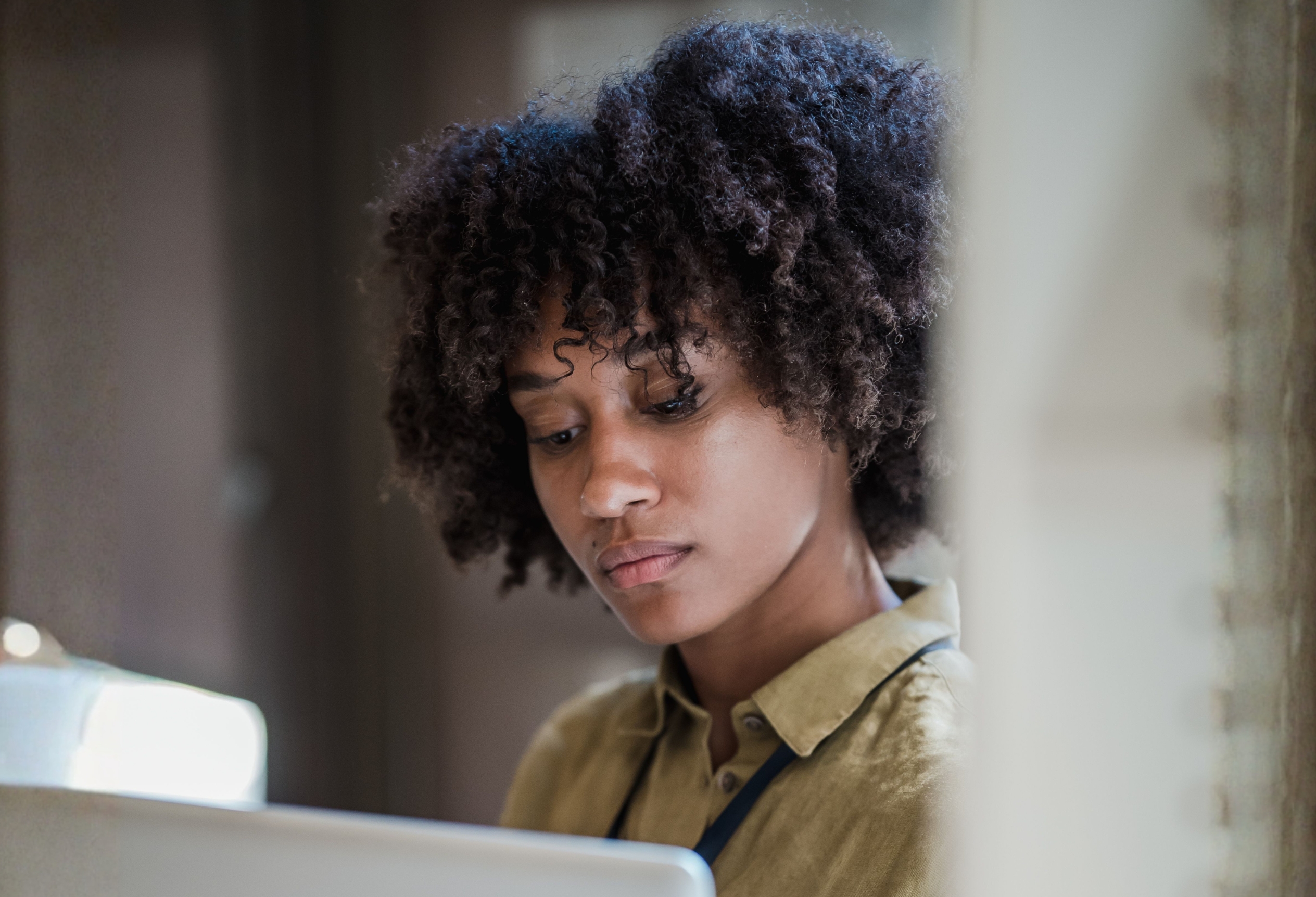 Woman reading thoughtfully at a laptop, the Unfold Psychology blog
