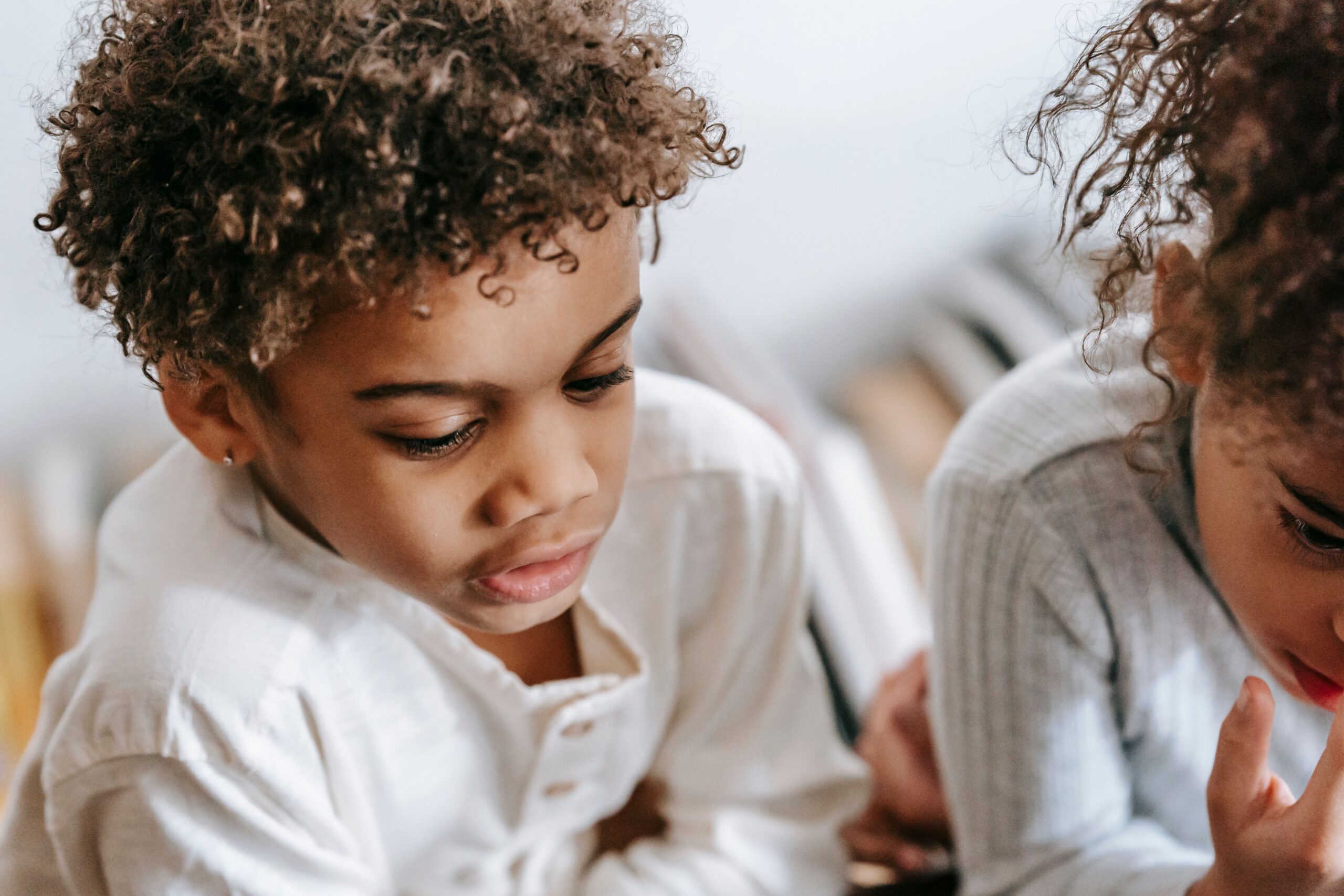 Child being held by a parent, child therapy at Unfold Psychology