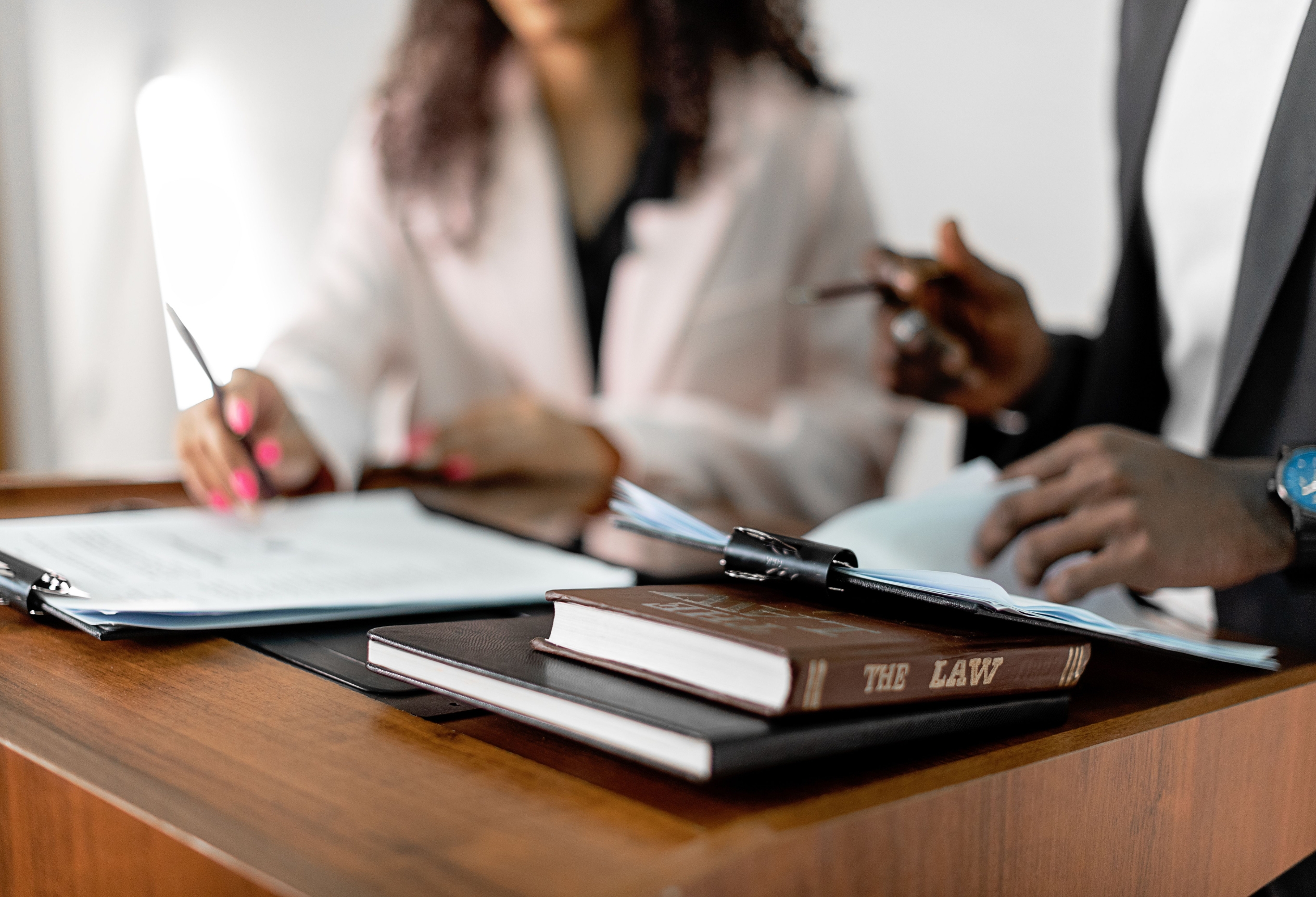Professionals reviewing documents at a table, forensic psychology services