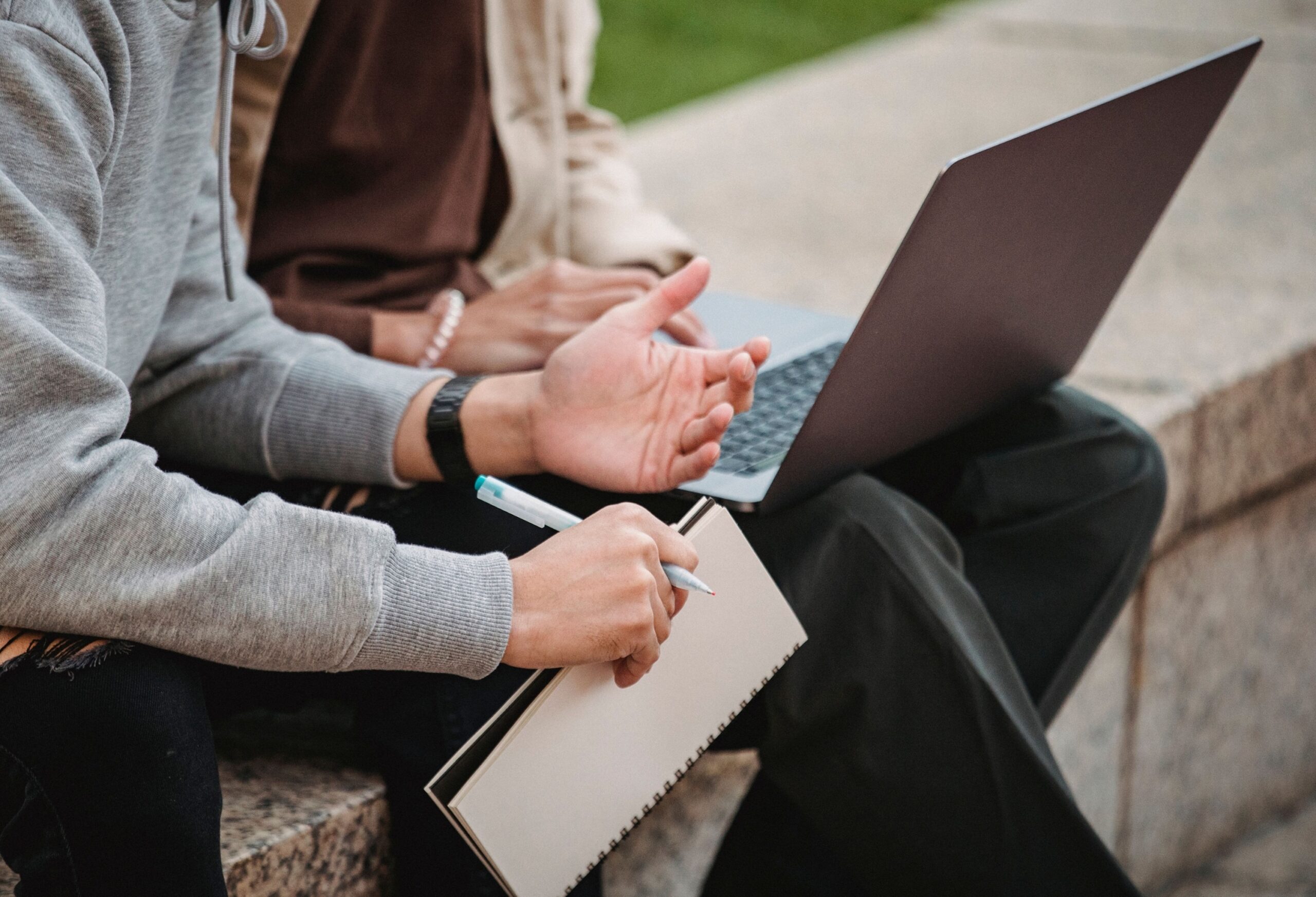 Two students working on a laptop together, high school and college acceptance support