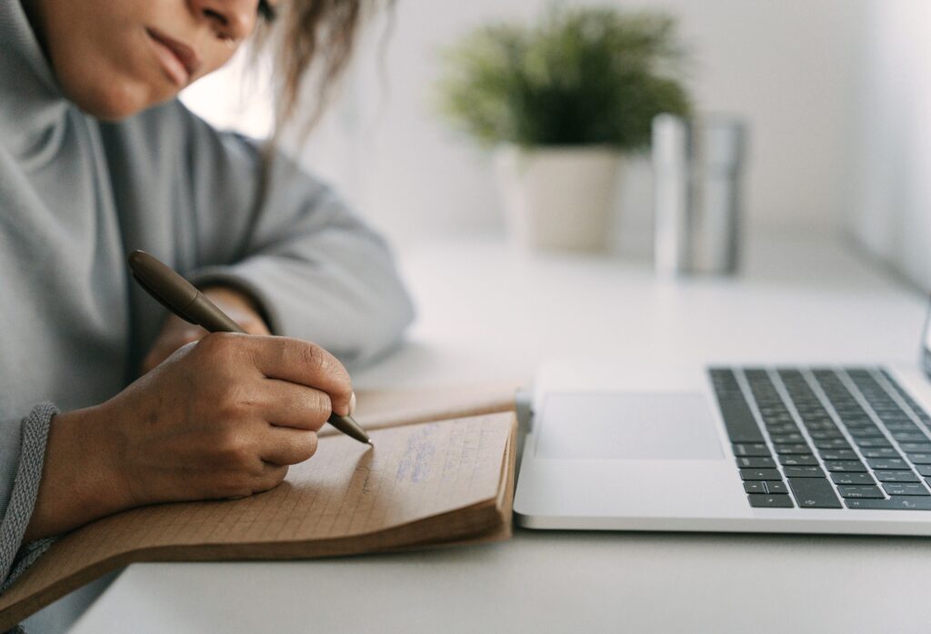 Student writing at a desk, single goal executive functioning program