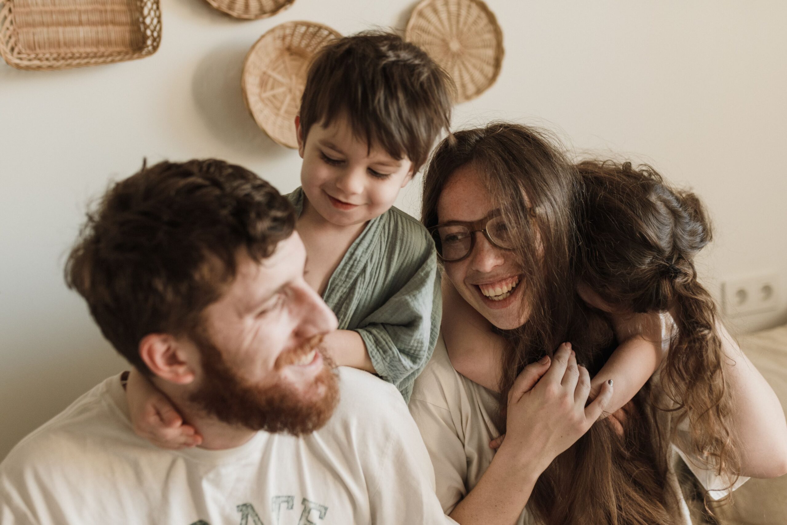 Parents and child embracing outdoors, family therapy at Unfold Psychology