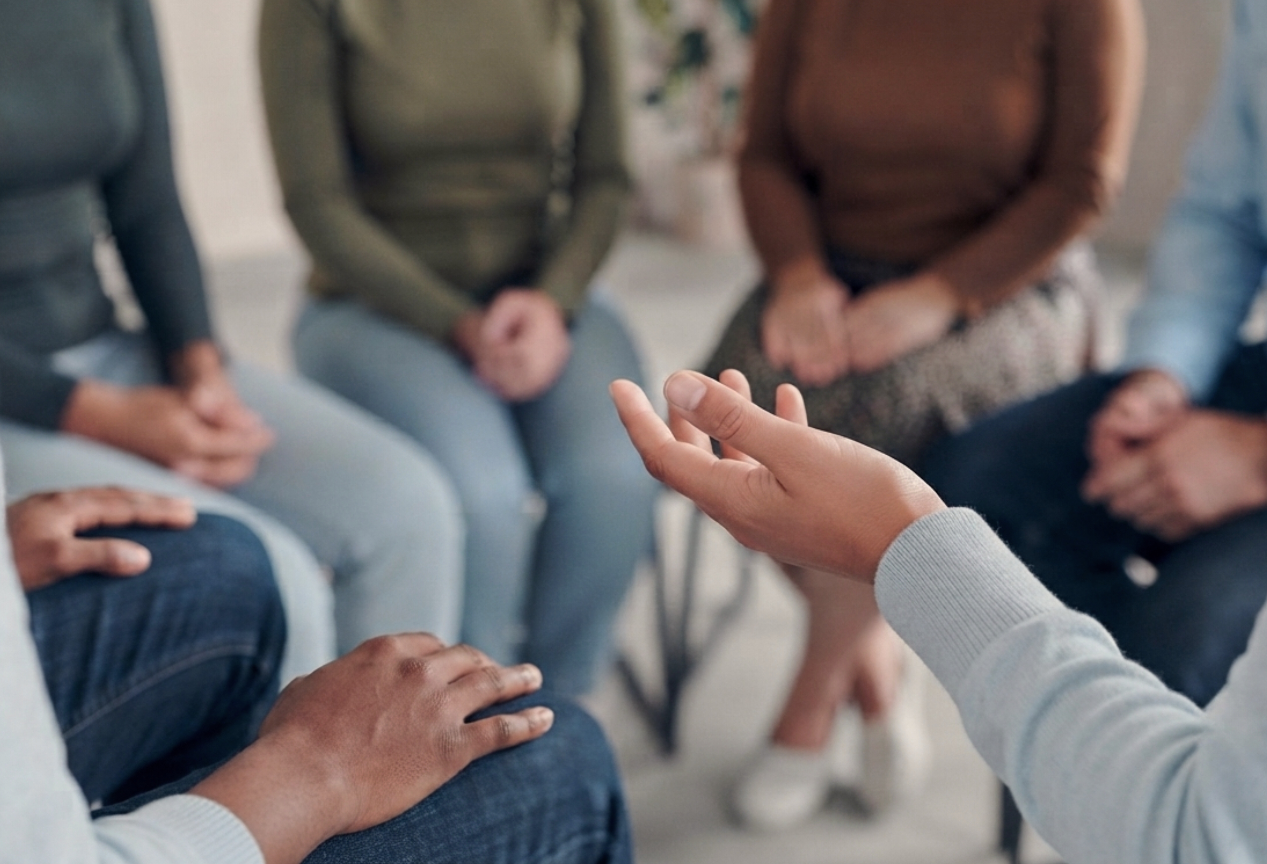 Group therapy session with participants seated in a circle