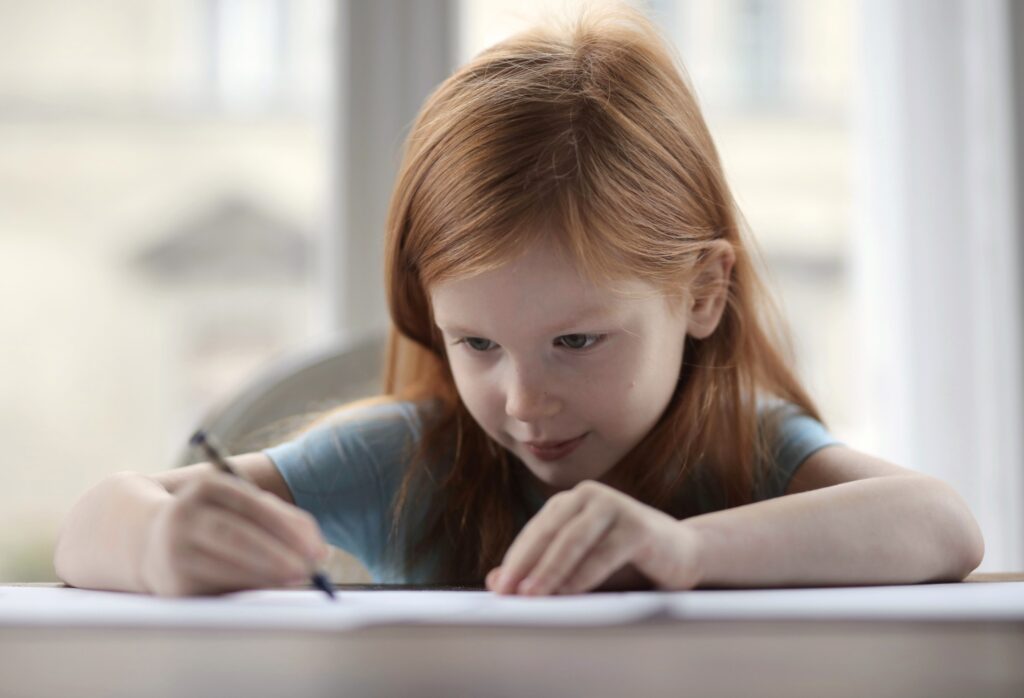 Child concentrating on a written test, IQ and school entrance testing