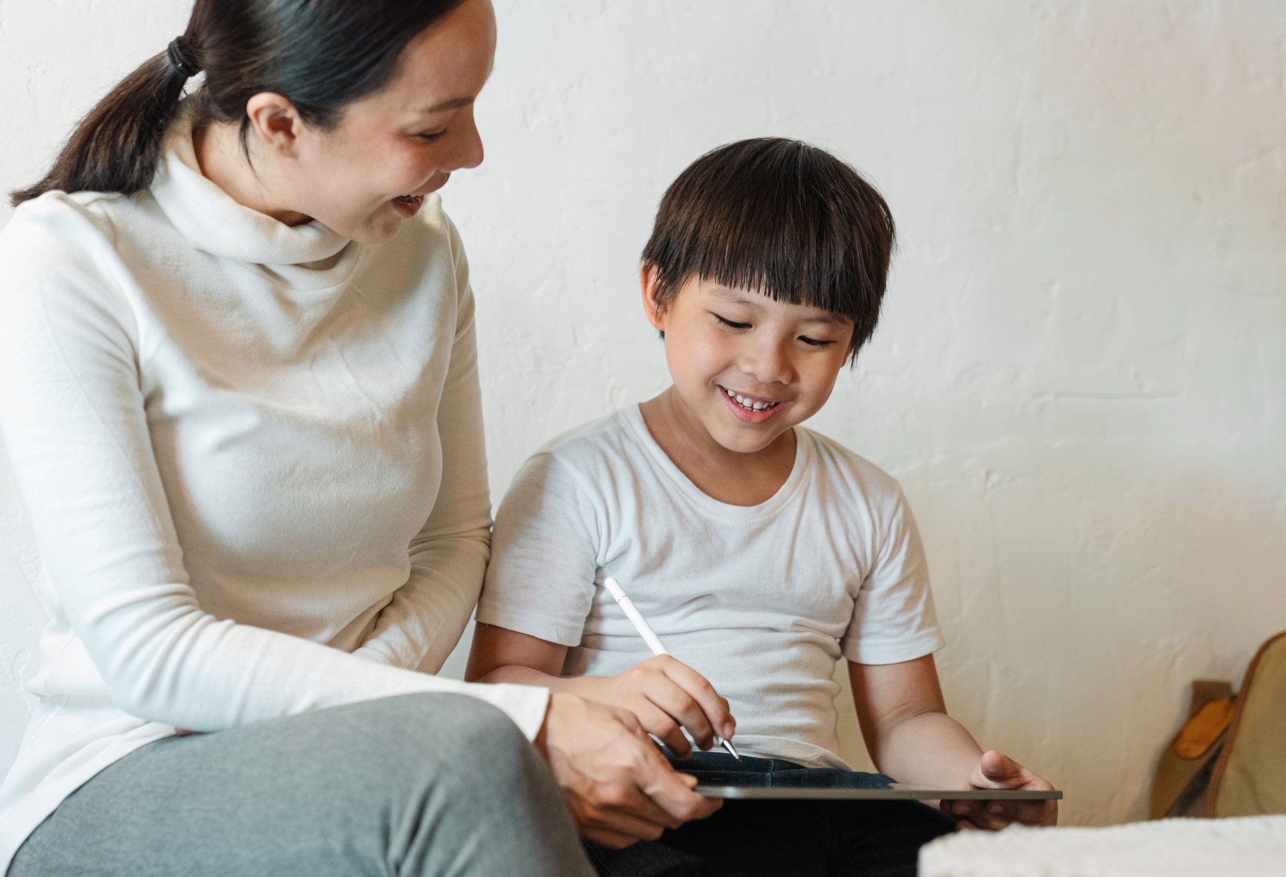 Parent and child looking at a tablet together, learning disability testing