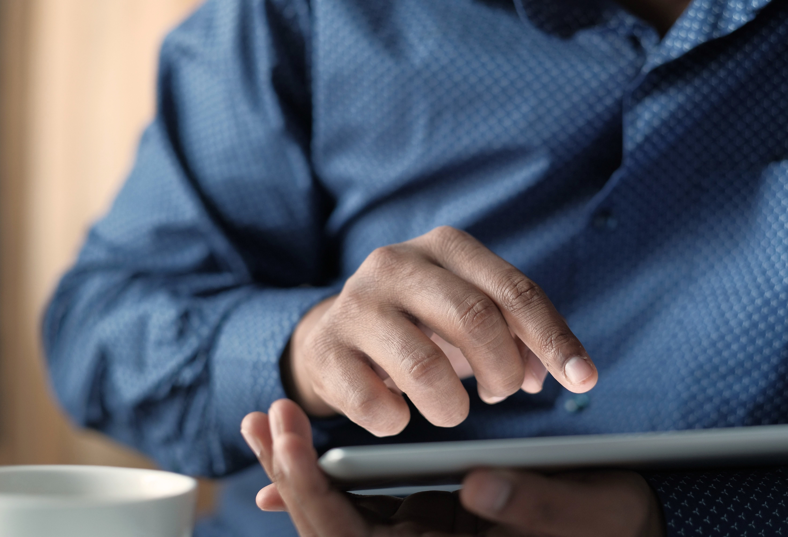 Hands using a tablet, cognitive training for post-concussion recovery